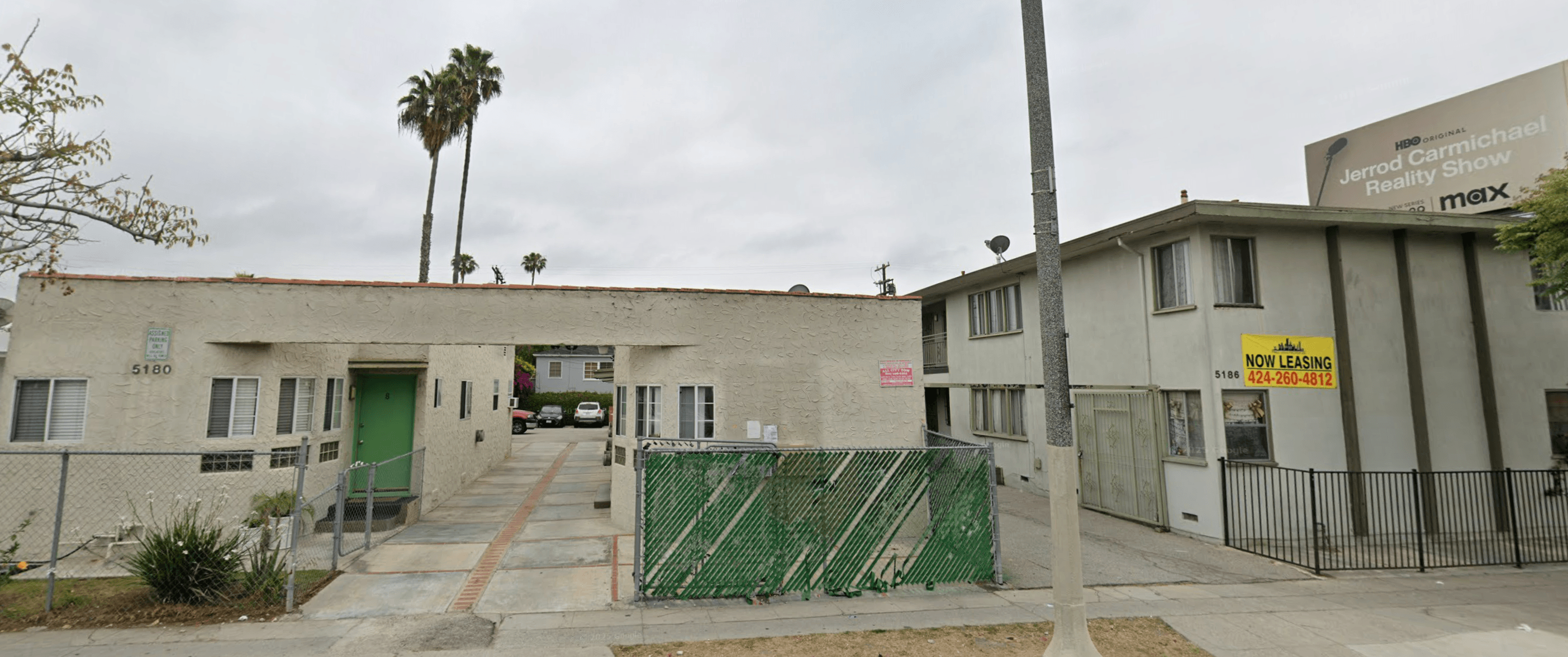 A building with a green gate in front of it.